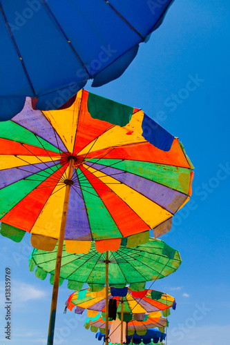 Old multicolored colorful umbrellas with wear tracks.
