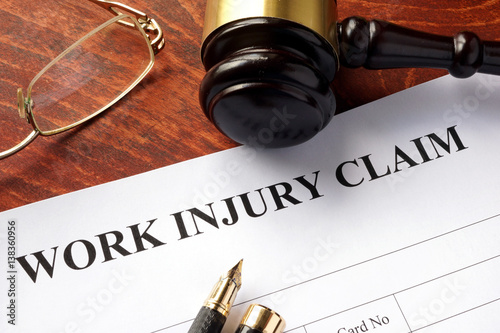Slika na platnu Worker compensation. Work injury claim on a table.