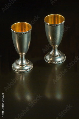 Two small vintage glasses from silver, inside gilded. The backgr