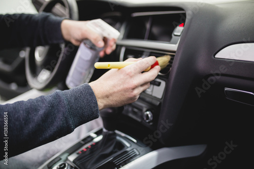 A man cleaning car interior, car detailing (or valeting) concept. Selective focus.  © hedgehog94