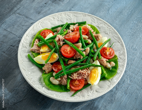 Fresh Tuna Green Bean salad with eggs, tomatoes, beans on white plate. concept healthy food