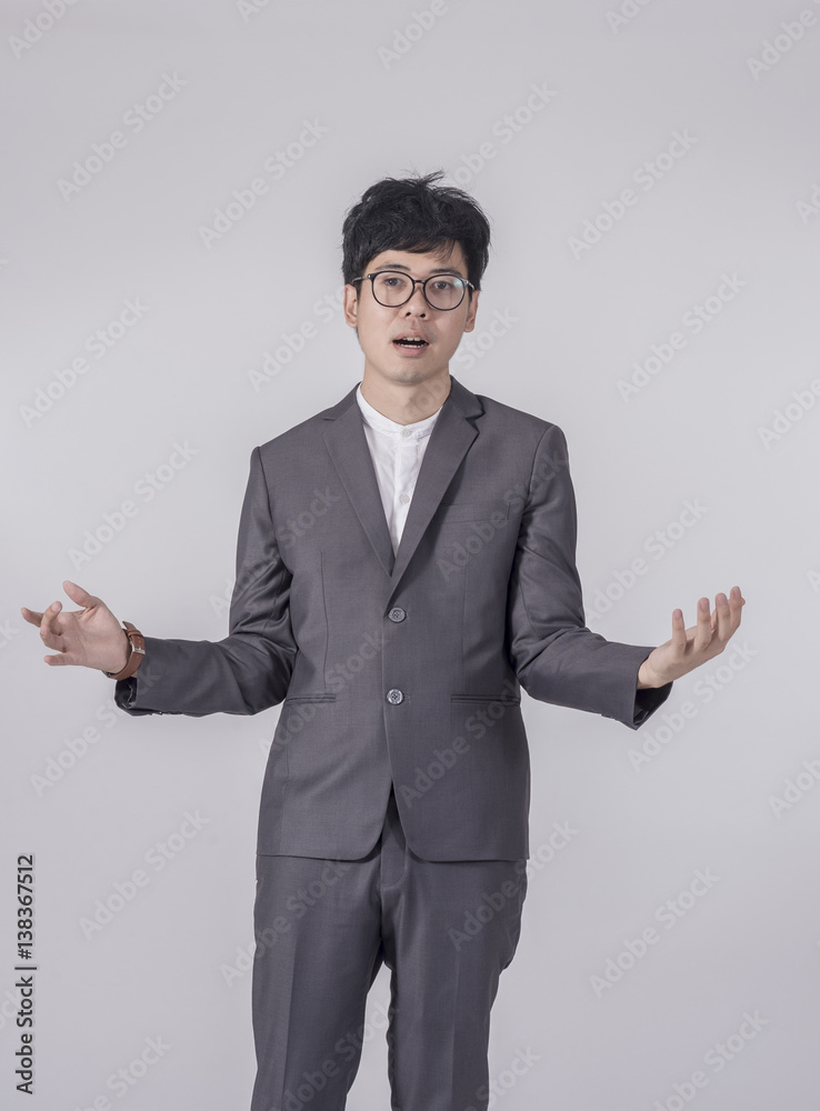 Young handsome business man in gray suit and glasses feel success with gray background Young handsome business man in gray suit and glasses feel success with gray background