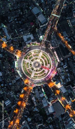 Road roundabout with car lots Wongwian Yai in Bangkok,Thailand. street large beautiful downtown at night light.  Aerial view , Top view ,cityscape ,Rush hour traffic jam
