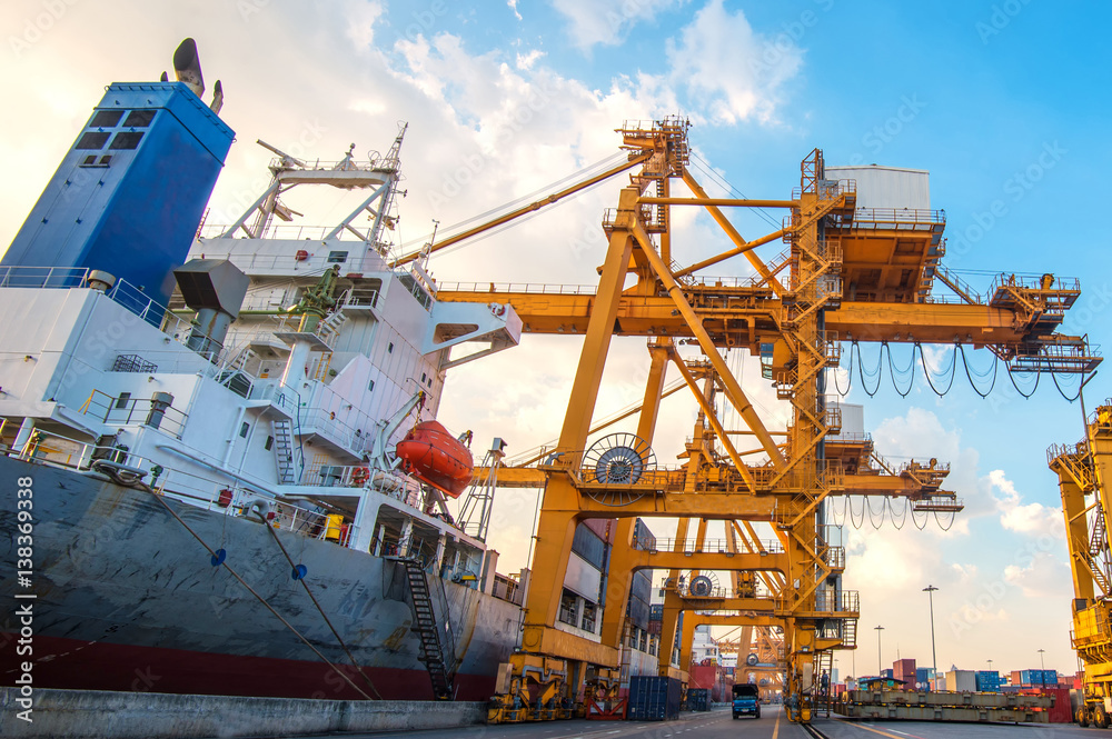 container ship in import export and business logistic.By crane ,Trade Port , Shipping.cargo to harbor.Aerial view.Water transport.International.Shell Marine.Top view.