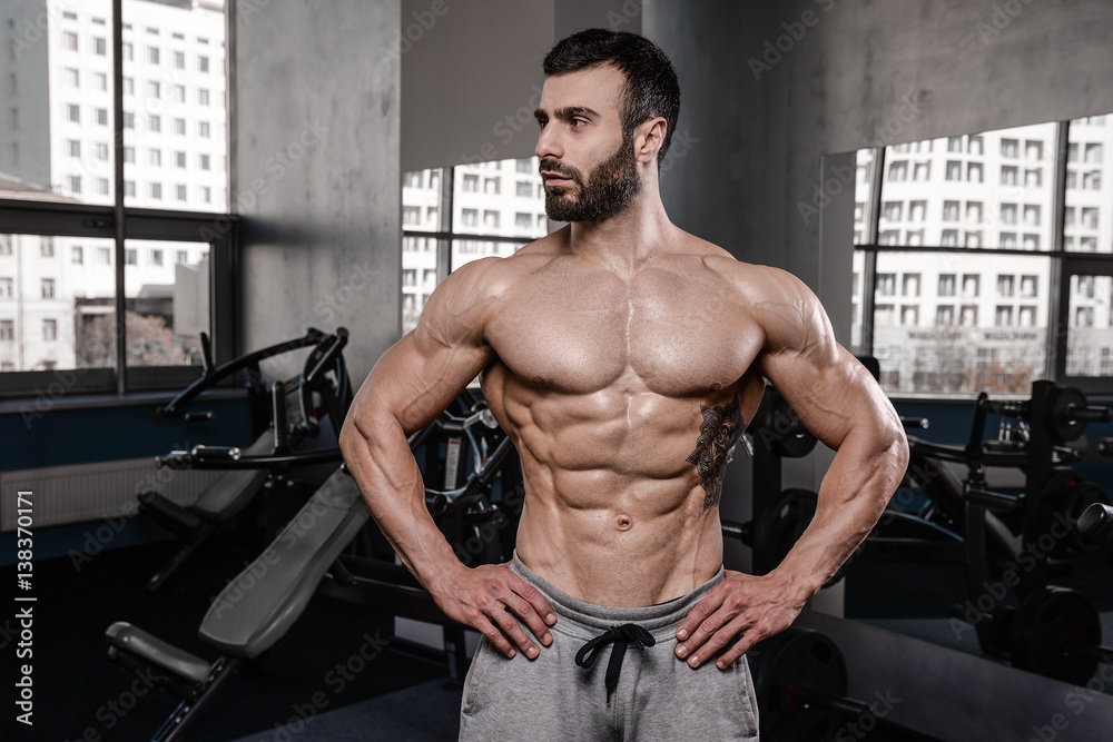Handsome fitness model train in the gym gain muscle. Handsome fitness model train in the gym gain muscle.