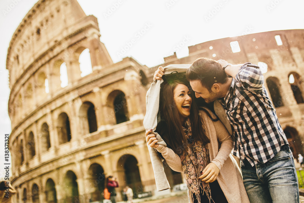 Loving couple in front of the Colosseum in Rome