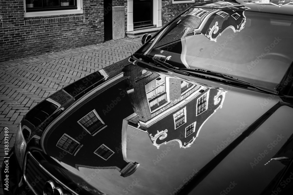 Naklejka premium Typical Dutch houses are reflected on the surface of the car in the village De Rijp, The Netherlands