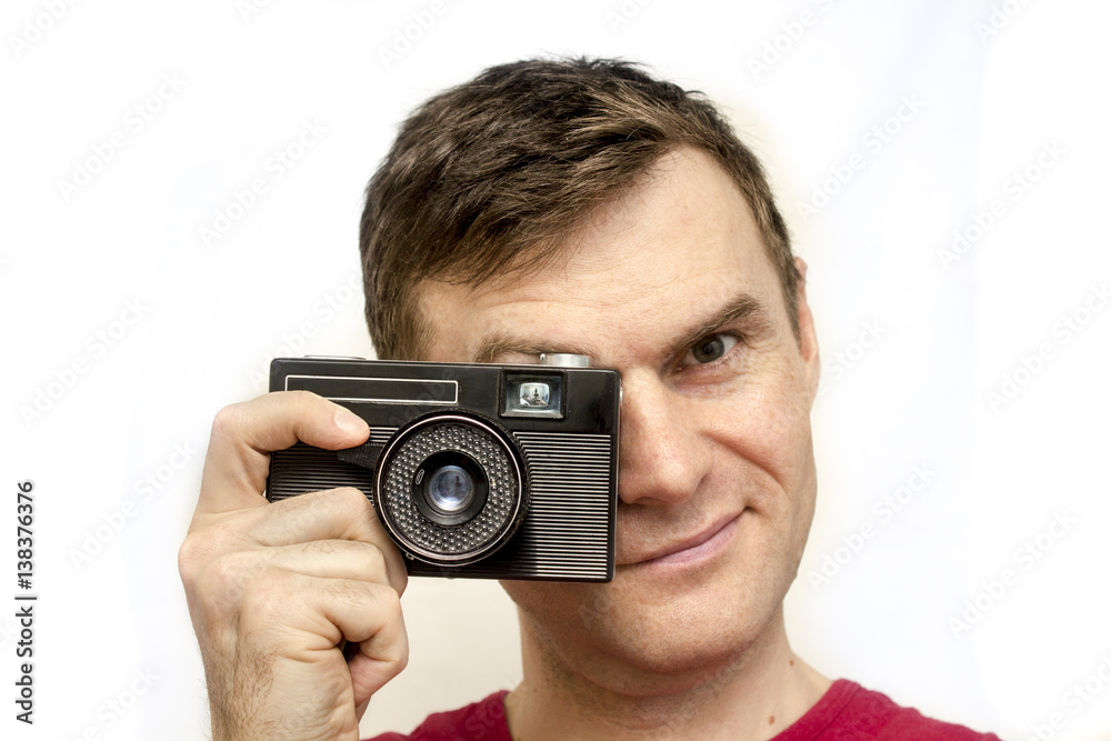 Man in a red shirt with old camera, white background Man in a red shirt with old camera, white background