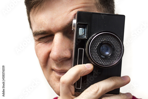 Man in a red shirt with old camera, white background © Alexander