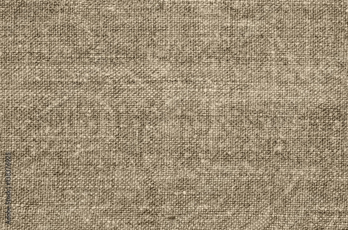 Homespun hemp cloth. Close-up of texture fabric cloth textile background. Homespun hemp fabric material. Homespun hemp canvas. Natural authentic cloth. Beige colour.