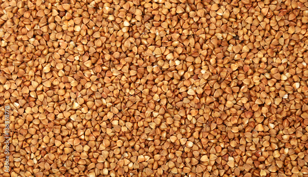 Dried brown buckwheat groats close up background Dried brown buckwheat groats close up background