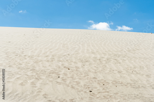 Stunning Mangawhai Heads sand dunes rising to blue sky 