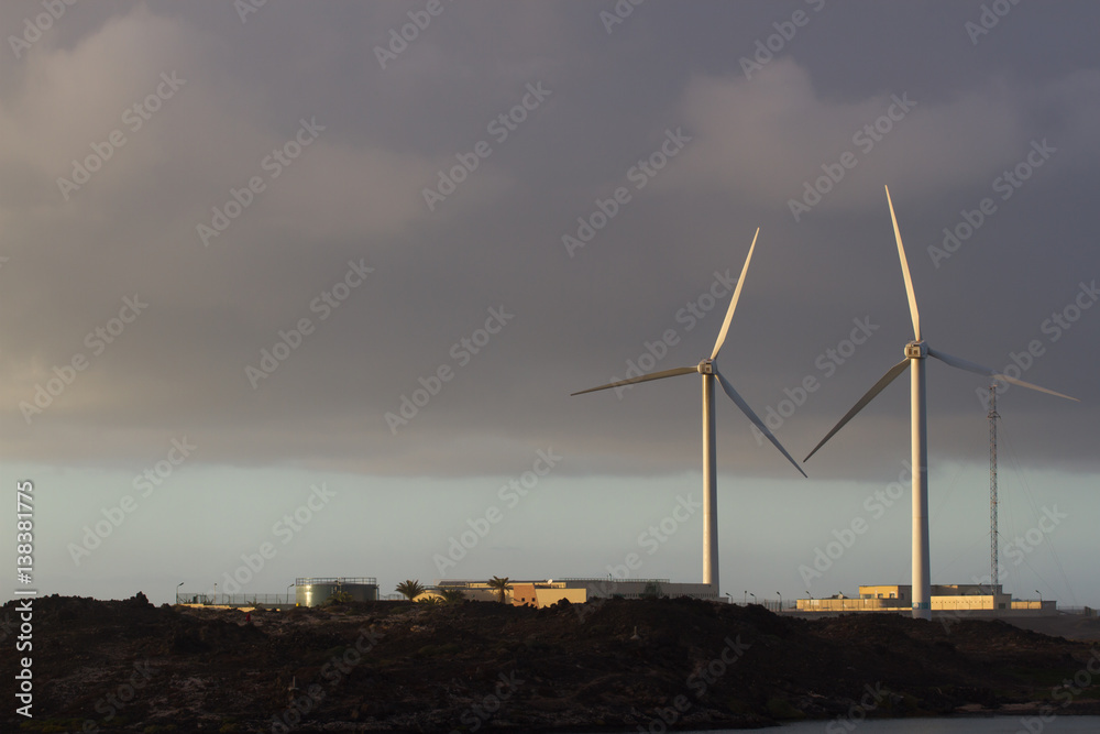 Two wind turbine move at sunset beautiful light, Spain, Fuerteventura island