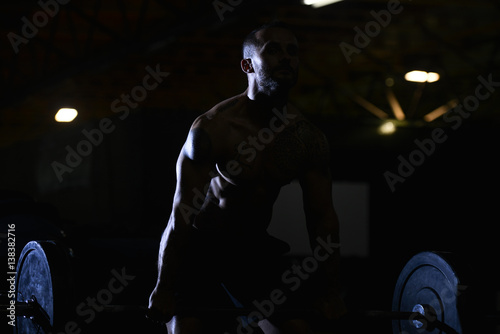 Silhouette Man Standing Strong In The Gym And Flexing Muscles - Muscular Athletic Bodybuilder Fitness Model Posing After Exercises
