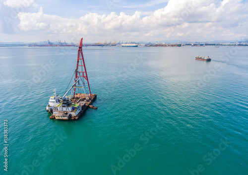 container ship in import export and business logistic.By crane ,Trade Port , Shipping.cargo to harbor.Aerial view.Top view.