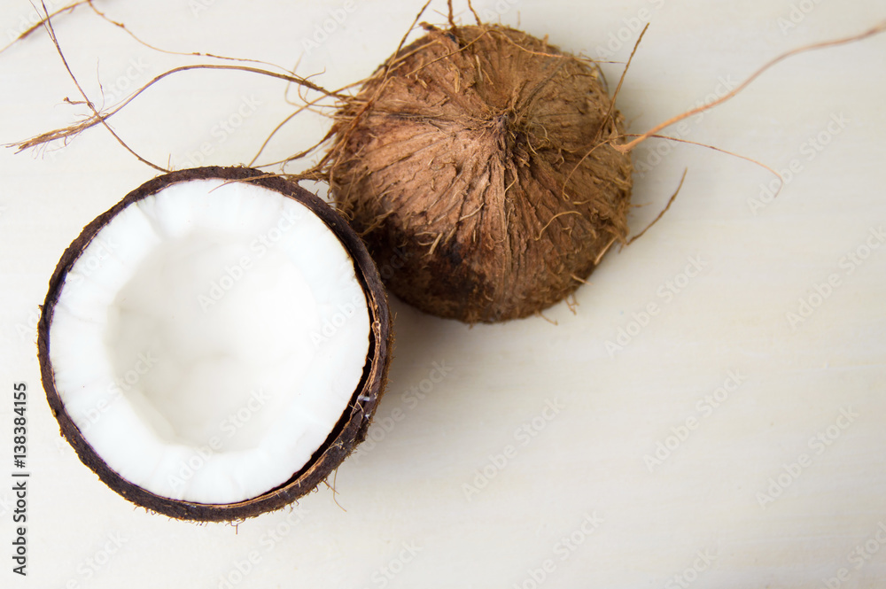 Halved coconut on a wooden table Halved coconut on a wooden table