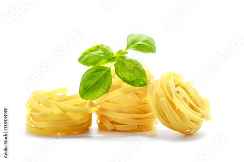 Italian pasta with basil isolated on white background