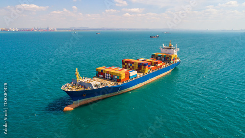 container ship in import export and business logistic.By crane ,Trade Port , Shipping.cargo to harbor.Aerial view.Top view.