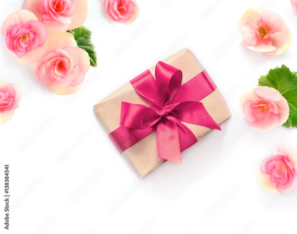 Gift box with red ribbon and bow on white with flowers background. flat lat, top view Gift box with red ribbon and bow on white with flowers background. flat lat, top view