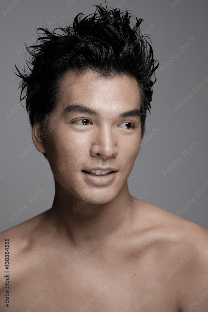 Portrait of Asian man with beauty honey skin tone in gray background - Headshot