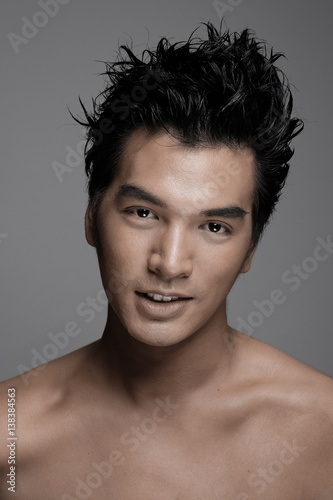 Portrait of Asian man with beauty honey skin tone in gray background - Headshot