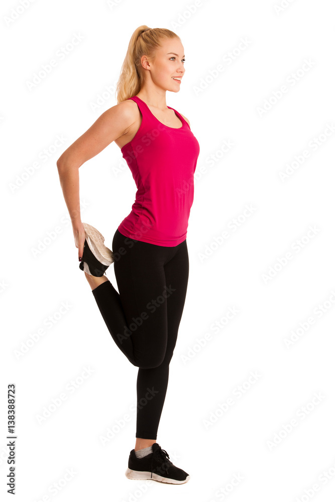 Beautiful young woman stretches leg isolated ovwer white background Beautiful young woman stretches leg isolated ovwer white background