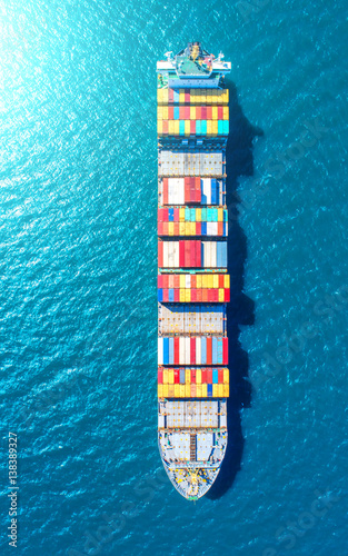 container ship in import export and business logistic.By crane ,Trade Port , Shipping.cargo to harbor.Aerial view.Top view.