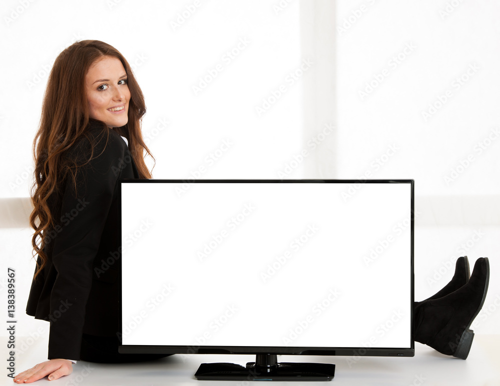 Beautiful business woman pointing to large screen with blank white copyspace for advertisement Beautiful business woman pointing to large screen with blank white copyspace for advertisement
