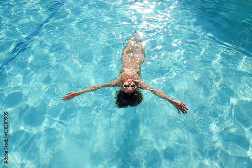 Wallpaper Mural Woman floating on back in swimming pool Torontodigital.ca