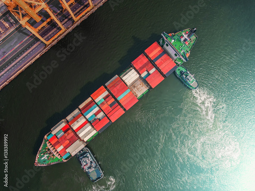 container ship in import export and business logistic.By crane ,Trade Port , Shipping.cargo to harbor.Aerial view.Top view.