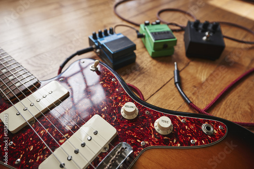 an electric guitar with cables and pedals photo