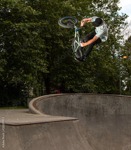 Man performing stunt on bike at skate park 