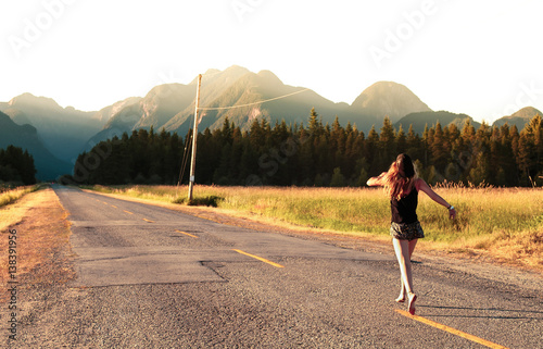 Barefoot woman running on road, Golden Ears Provincial Park, Canada