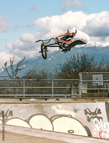 Man performing stunt on bike at skate park 