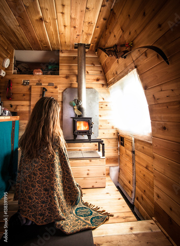 Woman sat in wooden clad camper van  photo