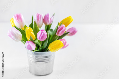 Fototapeta Naklejka Na Ścianę i Meble -  Bouquet of fresh tulips in a metal pot.