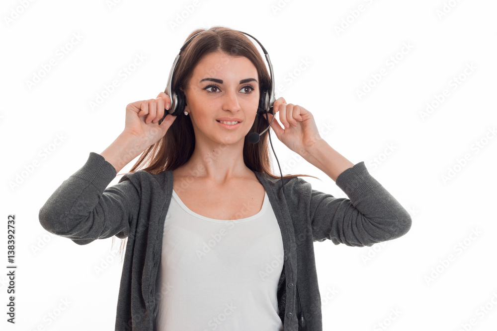 young lovely business woman in uniform with headphones and microphone looking away and smiling isolated on white background young lovely business woman in uniform with headphones and microphone looking away and smiling isolated on white background