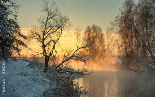 Winter landscape misty dawn on the winter river