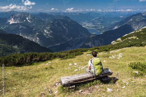 A man relaxing on the bench in Alps, Dachstein mountain.