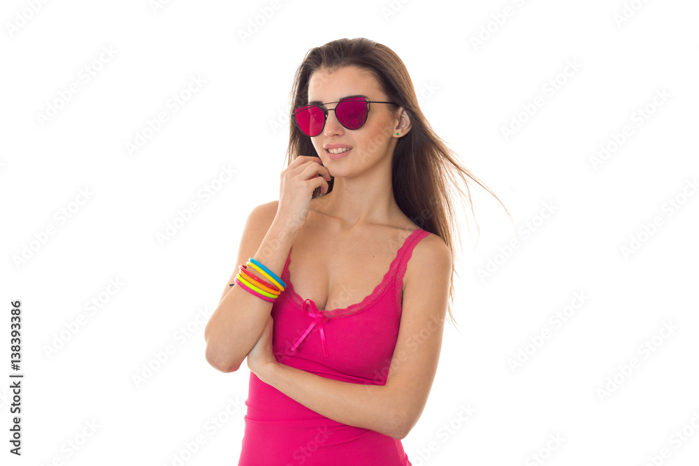 young attractive girl in pink shirt and sunglasses posing in studio isolated on white background young attractive girl in pink shirt and sunglasses posing in studio isolated on white background
