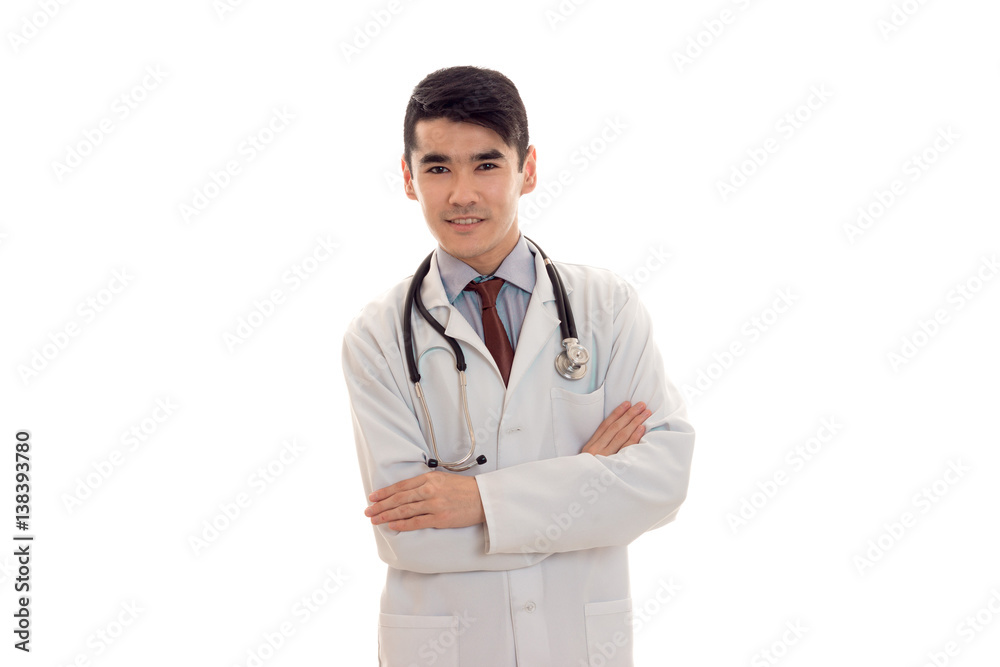 portrait of handsome brunette male doctor in uniform with stethoscope looking and smiling on camera isolated on white background portrait of handsome brunette male doctor in uniform with stethoscope looking and smiling on camera isolated on white background