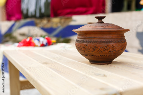 Vintage earthen pot Kooja of Kerala, India for storing water. Due to capillary action and subsequent evaporation from the surface, the water inside becomes cold. Natural refrigerator. photo