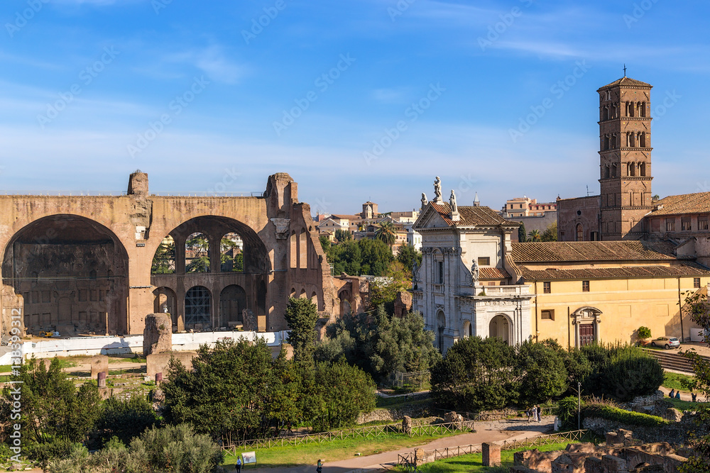 Rome, Italy. Basilica of Maxentius (left) and the medieval church of Santa Francesca Romana in the Roman Forum