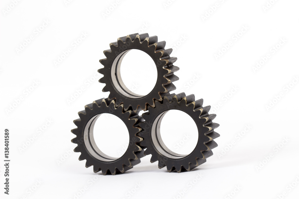 Small group of gears with their teeth engaged on a white background. Small group of gears with their teeth engaged on a white background.