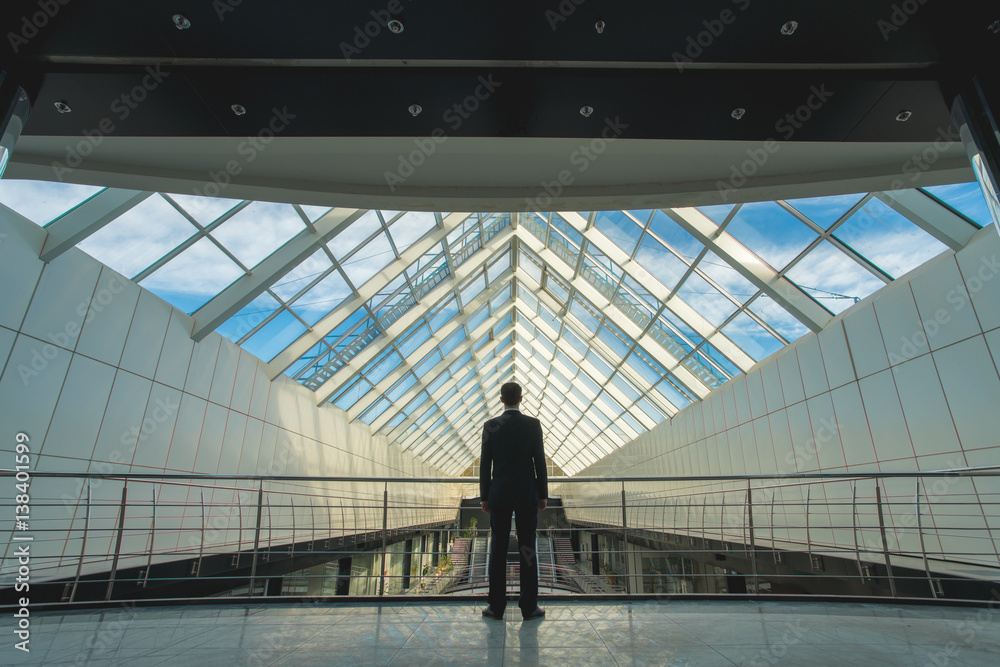 The man stand on the bridge in the business center The man stand on the bridge in the business center