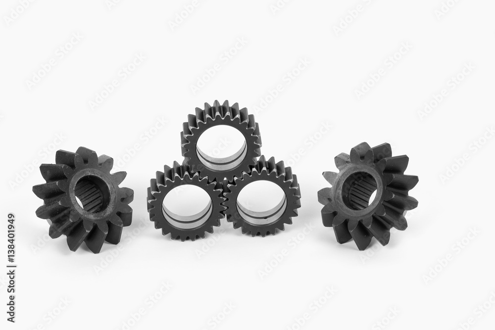 Small group of gears with their teeth engaged on a white background. Small group of gears with their teeth engaged on a white background.
