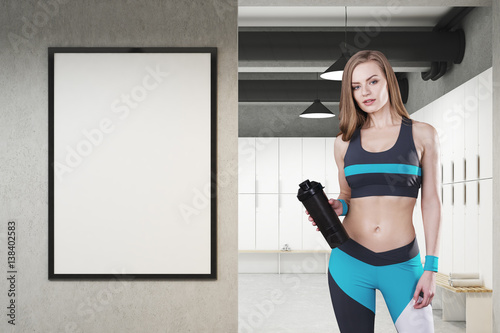 Girl in locker room with framed poster, front