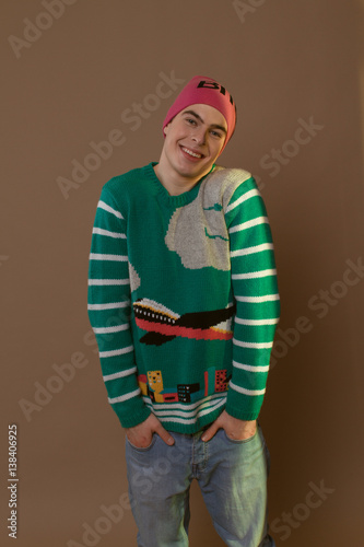Cute guy in hipster clothes 90s posing in studio