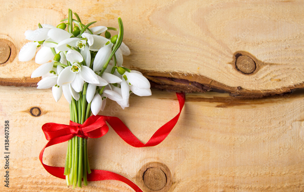 Snowdrops bouquet on natural wooden board Snowdrops bouquet on natural wooden board