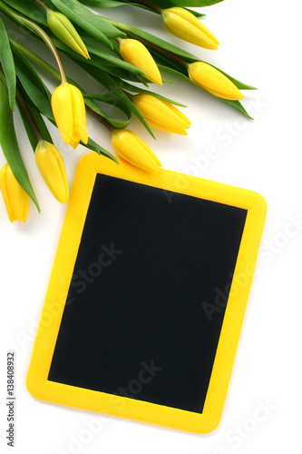 Blackboard with yellow tulips